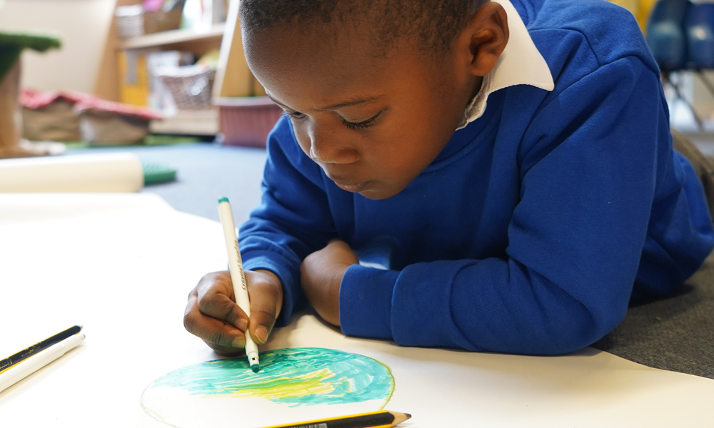 EYFS child drawing a swamp